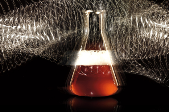 A dramatic image capturing a conical flask with a glowing red liquid at its base, surrounded by a mesmerizing swirl of light trails against a dark background, creating a sense of wonder akin to a modern alchemical experiment.